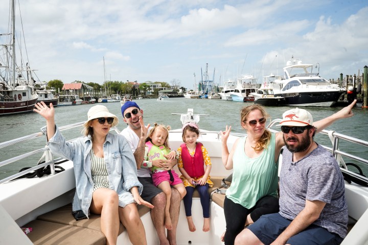 a group of people sitting at a dock