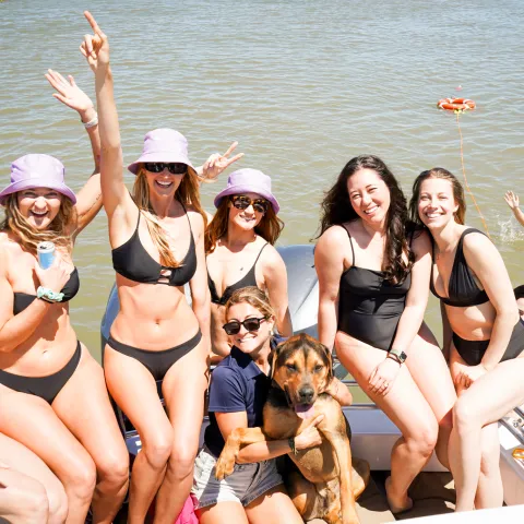 a group of people in a boat on a body of water