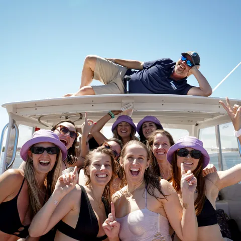 a group of people on a boat posing for the camera