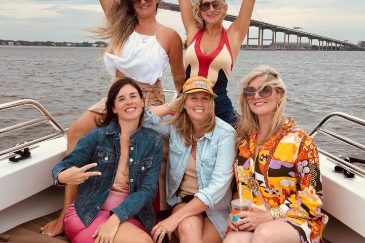 a group of people on a boat posing for the camera