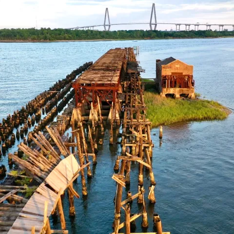 a wooden pier next to a body of water