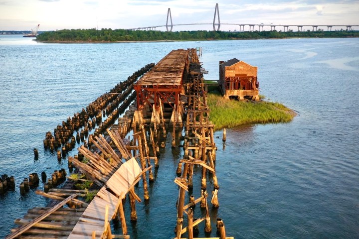 a wooden pier next to a body of water