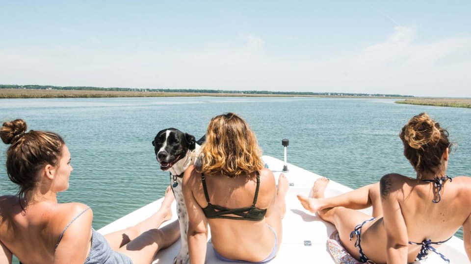 a couple of people that are sitting in front of a body of water