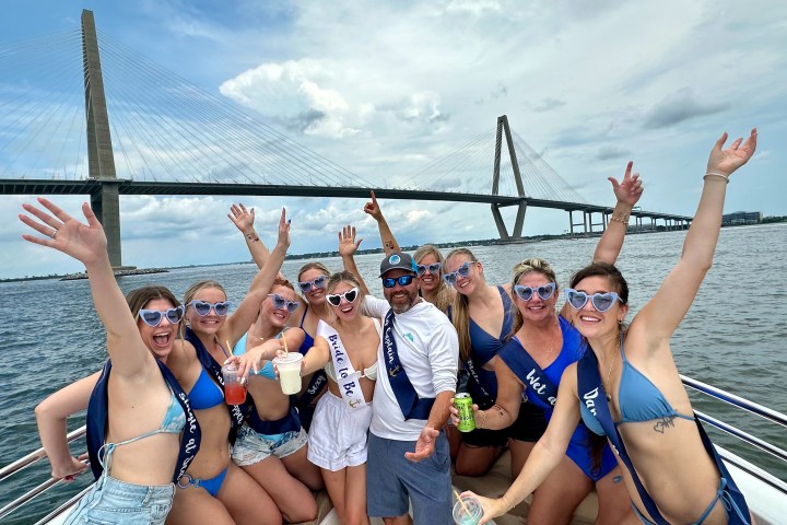 a group of people standing next to a body of water