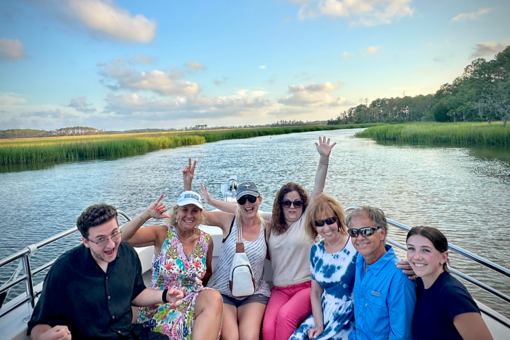 a group of people sitting in front of a body of water