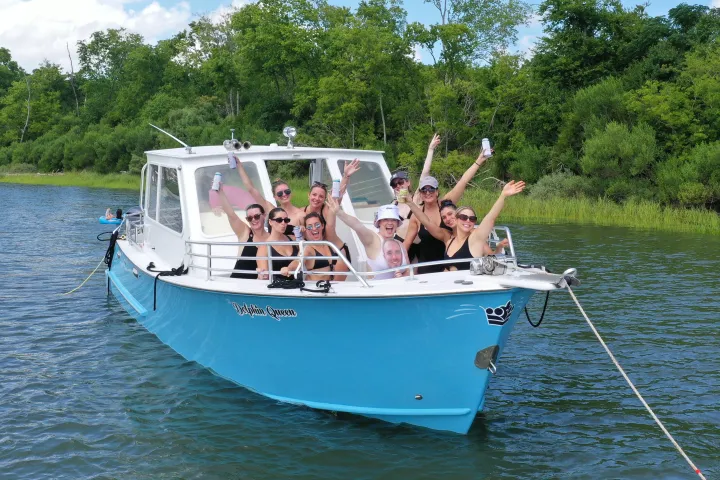 a medium size boat in a body of water with bachelorettes