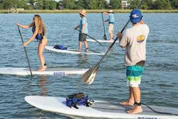 a group of people rowing a boat in a body of water