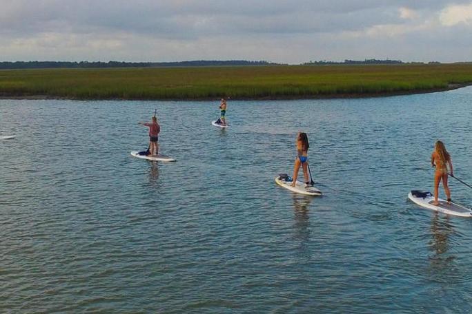 a group of people in a small boat in a body of water