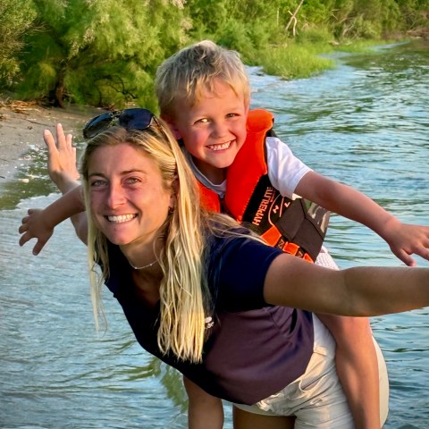 a person standing next to a body of water