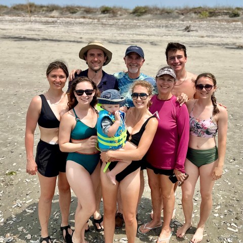 Lucia Annunziata et al. standing on a beach posing for the camera